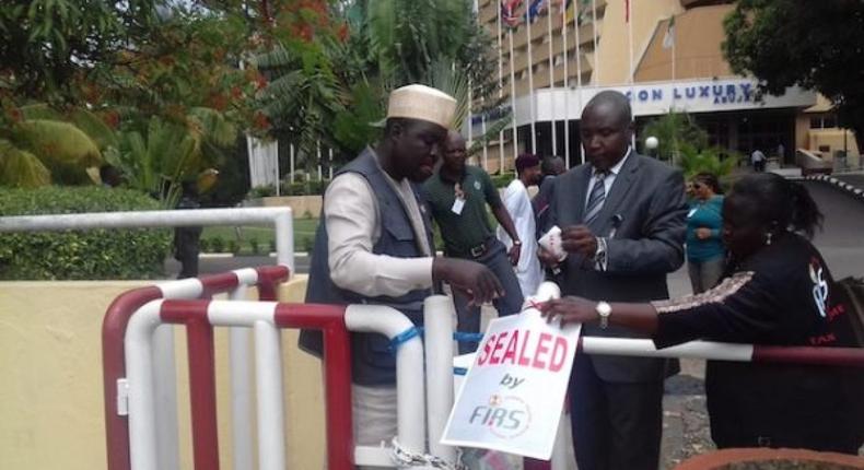 Officials of the federal Inland Revenue Services sealing a office (TheCable)