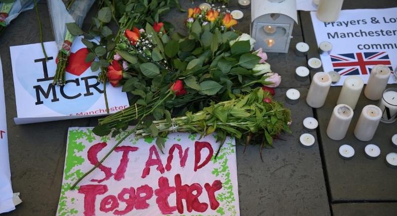 Candles, sings and floral tributes left at a vigil after a suicide bombing at an Ariana Grande concert in Manchester, England