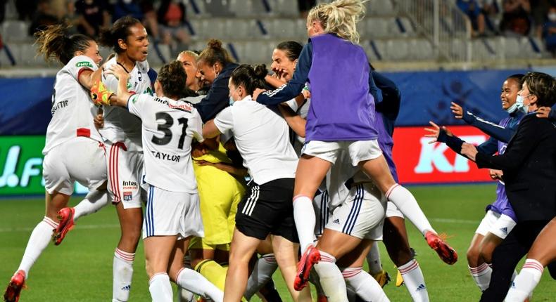 Lyon's players celebrate with Sarah Bouhaddi after she saved the key penalty