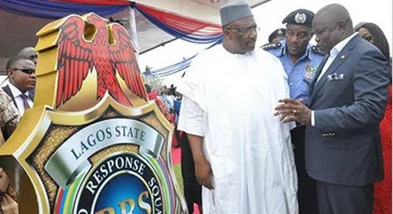 Governor Akinwunmi Ambode; Inspector General of Police, Mr. Solomon Arase and Minister for Interior, Lt.Gen.Abdulrahman Dambazua (rtd.), during the unveiling of Rapid Response Squad (RRS) logo at the commissioning and handing over  of patrol vehicles etc.