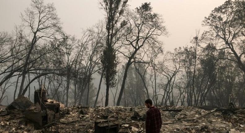 Jhonathan Clark walks in what was his house, destroyed by the Camp Fire, in Paradise -- his brother is among the missing