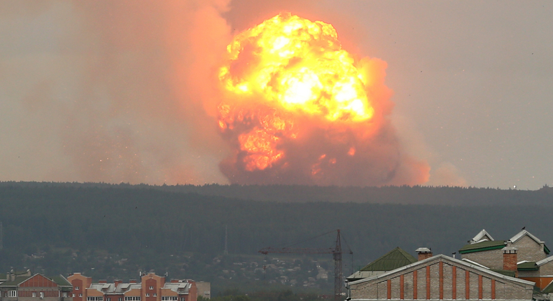 A view shows flame and smoke rising from the site of blasts at an ammunition depot in Krasnoyarsk region