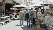 Francesco Del Grosso, center left, chief of the foreign crimes section at the national police unit in Palermo, and plainclothes police officers mix with shoppers and tourists in a market in Ballaro. (Valentino Bellini/For The Washington Post)