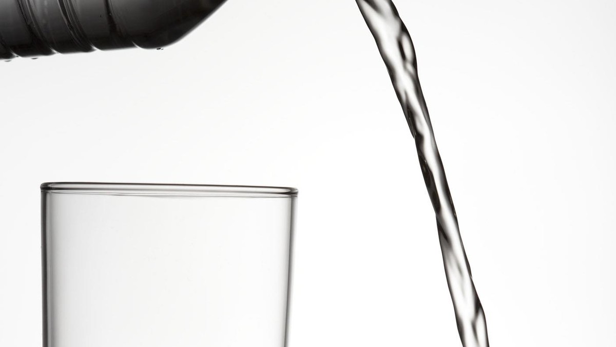 Close-up of water being poured outside of a glass