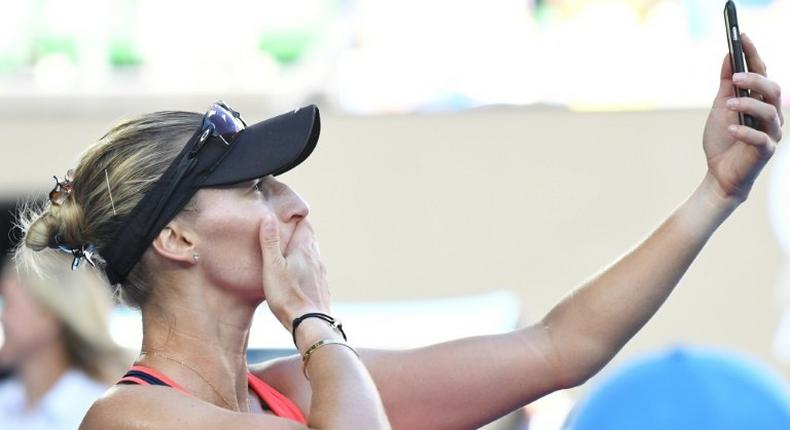Croatia's Mirjana Lucic-Baroni films the crowd with her phone following her defeat to Serena Williams of the US in their Australian Open semi-final in Melbourne on January 26, 2017