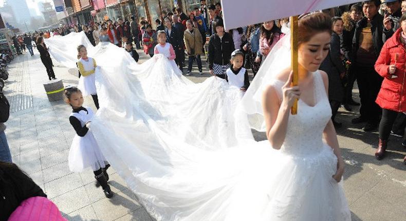 Woman models longest wedding dress ever