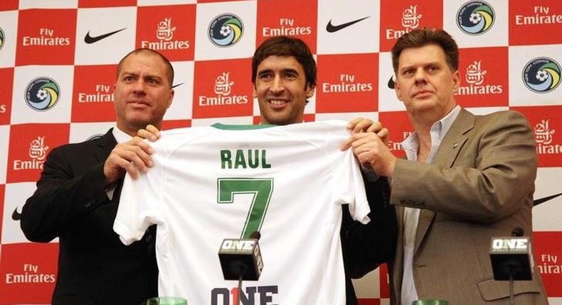 From left New York Cosmos head coach Gioavanni Savarese , player Raul Gonzalez and team chairman Seamus O'Brien pose for a photo with a jersey during a press conference at Four Seasons Hotel. Mandatory Credit: Noah K. Murray-USA TODAY Sports