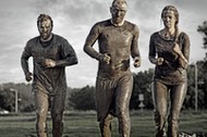 group of people jogging in mud