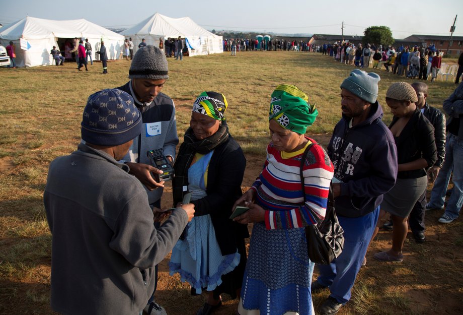 Election officials scan voters identity documents at a voting station during South Africa's local government elections in Umlazi, Durban, South Africa, August 3, 2016.