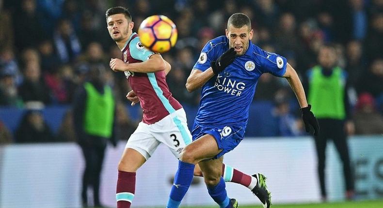West Ham United's defender Aaron Cresswell (L) vies with Leicester City's striker Islam Slimani during an English Premier League football match at King Power Stadium in Leicester, central England on December 31, 2016