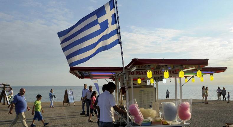 A candy floss stand carrying the Greek national flag.