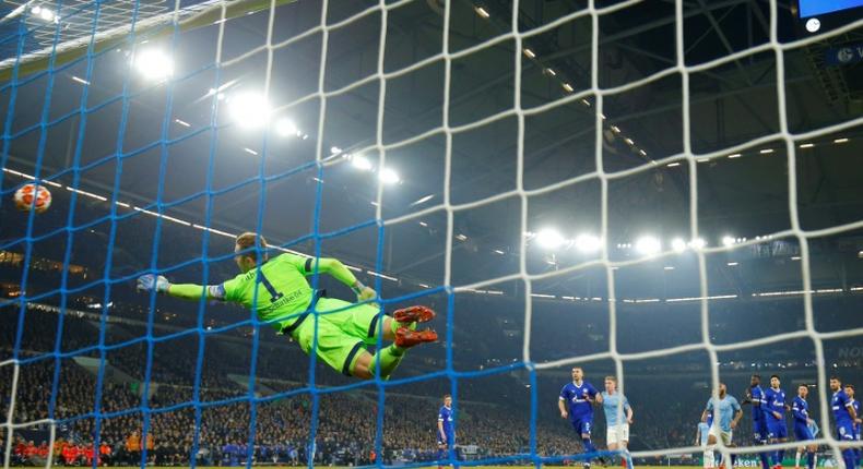 Schalke's German goalkeeper Ralf Faehrmann is beaten by Leroy Sane's stunning free-kick as Manchester City equalised before Raheem Sterling scored the late winner to seal a 3-2 victory in the Champions League, last 16, first leg match on Wednesday.