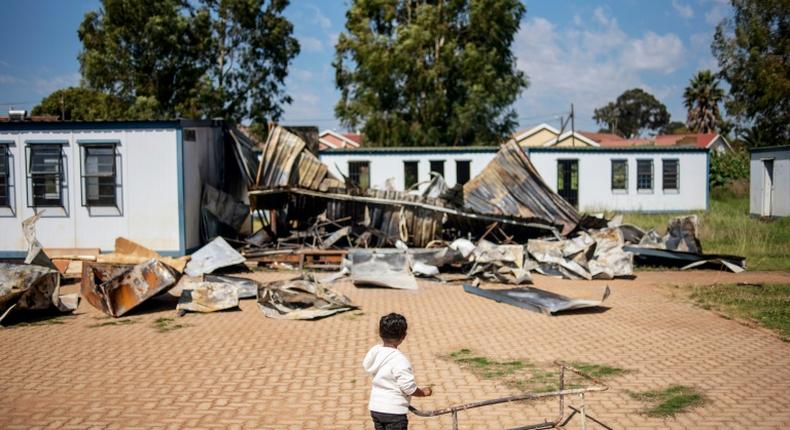 A young member of the 'Coloured' community stands in the courtyard of Oakdale Secondary School in Eldorado Park, on the outskirts of Johannesburg. Several classrooms were destroyed during a student strike in April