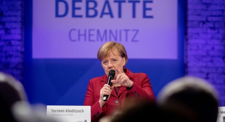 Merkel spent half a day in the former communist city of Chemnitz meeting residents, but tensions were clear with about one hundred far-right protesters marching and the city mayor criticizing her