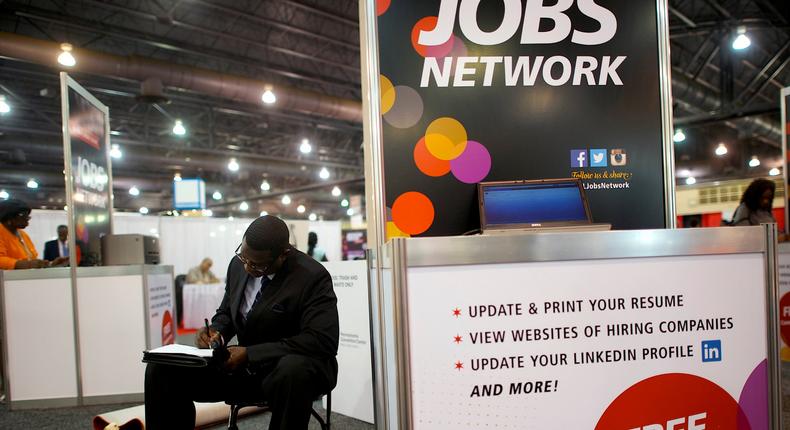 FILE PHOTO: A job-seeker completes an application at a career job fair in Philadelphia, Pennsylvania, U.S. July 25, 2013.  REUTERS/Mark Makela/File Photo   GLOBAL BUSINESS WEEK AHEAD