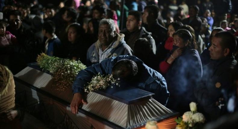 Family and friends mourn the death of their loved ones during the massive wake in San Isidro Chilchotla, Puebla state, Mexico on May 9, 2017, after an explosion at a fireworks warehouse killed 14, all but three of them children