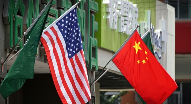 The US (L) and Chinese flags (R) displayed outside a hotel in Beijing