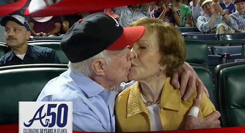 Former President Jimmy Carter kisses his wife Rosalynn on the “Kiss Cam during a baseball game between the Atlanta Braves and the Toronto Blue Jays on Sept. 17, 2015