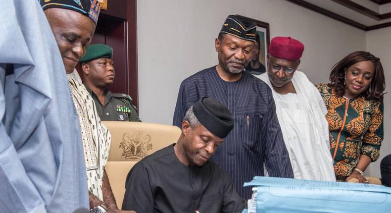 Acting President Yemi Osinbajo signing the 2017 appropriation bill on Monday, June 12, 2017 at the Presidential Villa in Aso Rock, Abuja