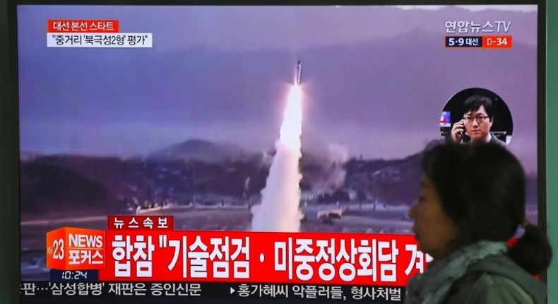 A TV screen shows file footage of a North Korean missile launch, with China's top nuclear envoy now in Seoul for talks on the North Korean threat