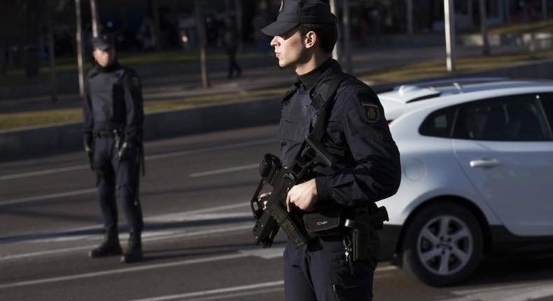 An armed Spanish police officer stands guard during a security operation at Colon square in central Madrid January 13, 2015. 