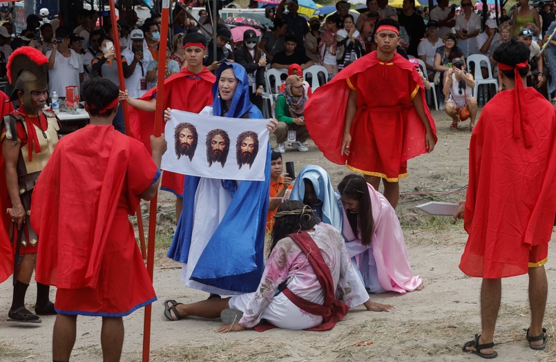 Catholic penitent nailed to cross on Good Friday in Holy Week of Lent