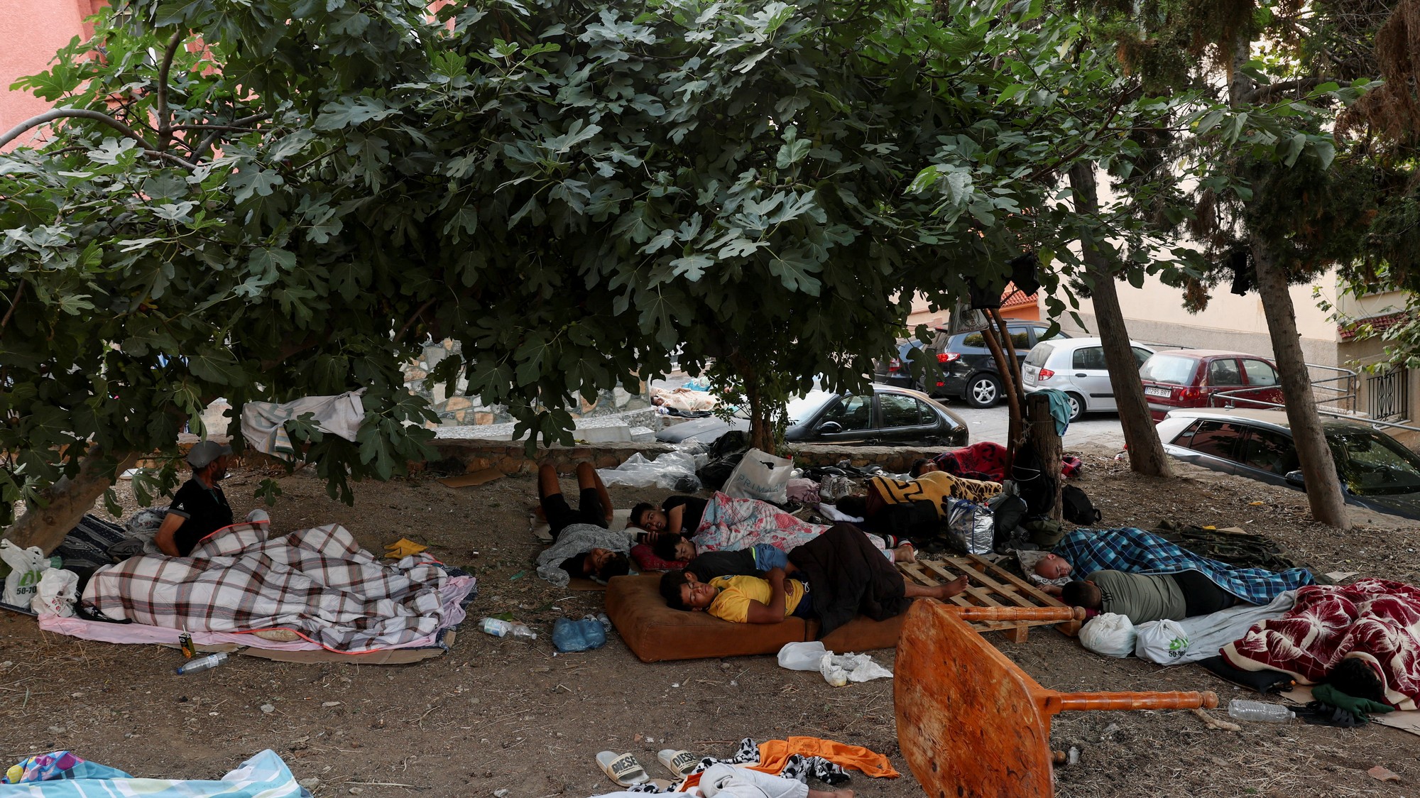 Mladí migranti spia v záhrade uprostred nedávnych hromadných prechodov z Maroka na španielske územie Ceuty po súši aj po mori.