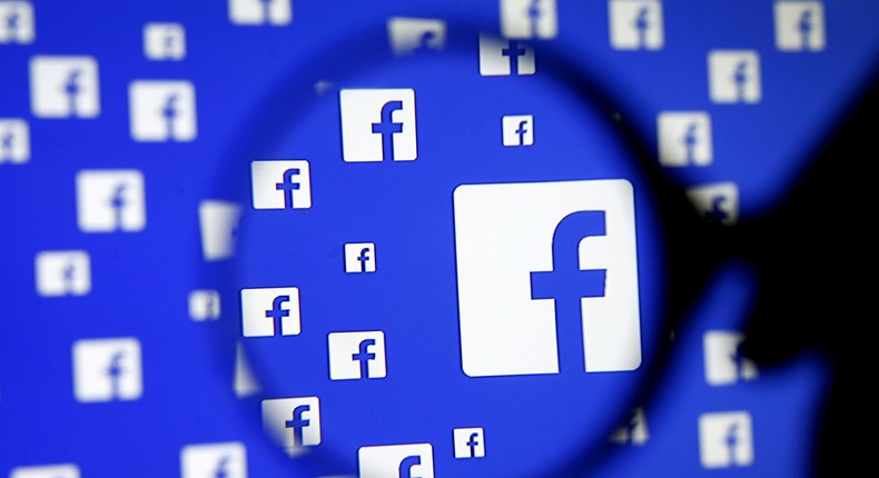 FILE PHOTO: A man poses with a magnifier in front of a Facebook logo on display in this illustration taken in Sarajevo, Bosnia and Herzegovina, December 16, 2015.   REUTERS/Dado Ruvic/Illustration