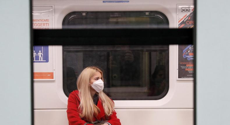 coronavirus train milan face mask