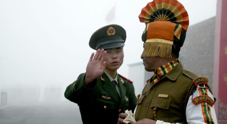Chinese and Indian soldiers stand guard at the Nathu La border crossing in India's northeastern Sikkim state, near the disputed Doklam territory