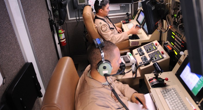 Capt. Ryan Jodoi flies an MQ-9 Reaper as Airman 1st Class Patrick Snyder controls a full-motion video camera at Kandahar Air Base, Afghanistan, March 13, 2009.