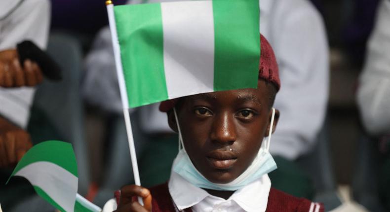 A young boy holds the flag of Nigeria.KOLA SULAIMON/AFP via Getty Images