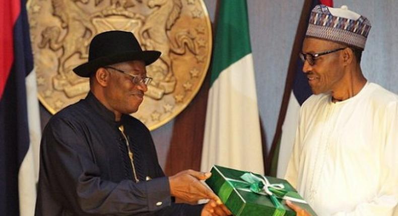 Former President Goodluck Jonathan presenting hand-over documents to President Muhammadu Buhari