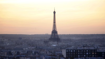 The Eiffel Tower is seen at sunset in Paris