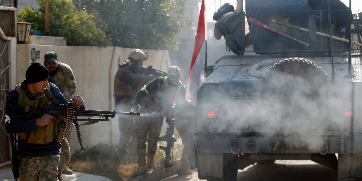 Members of the Iraqi rapid-response forces clashing with ISIS militants in the Mithaq district of eastern Mosul on January 5.