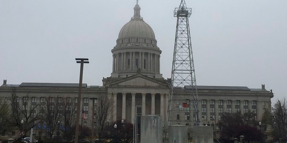 An oil-drilling rig near a parking lot in front of the state capitol building in Oklahoma City.