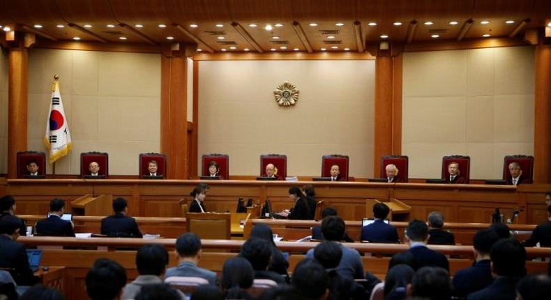 Nine judges of South Korea's Constitutional Court attend the first full hearing on whether to confirm the impeachment of President Park Geun-hye