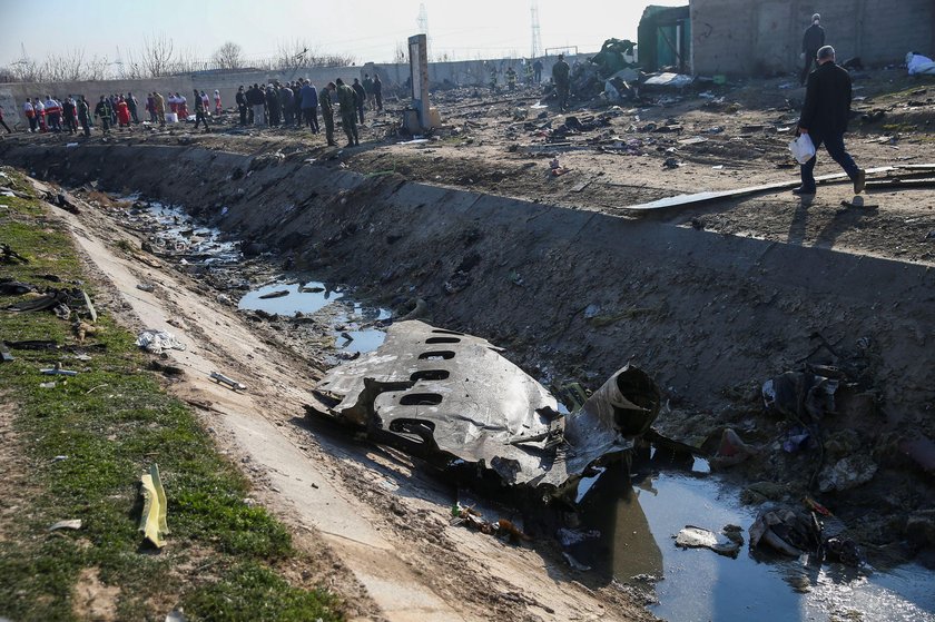 Emergency workers work near the wreckage of Ukraine International Airlines flight PS752, a Boeing 73