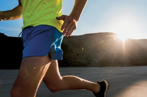 France, Crozon peninsula, young man running on the beach