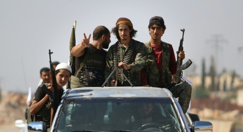 Syrian rebel fighters are seen in the northern countryside of Idlib province on September 11, 2018