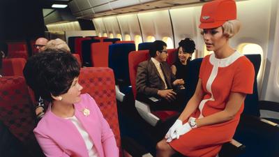 A United flight attendant wears the airline's coral-red uniform in May 1968.Dean Conger/Corbis via Getty Images