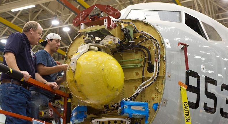 Boeing and Raytheon employees install of an APY-10 radar antenna on P-8A Poseidon aircraft in November 2009.
