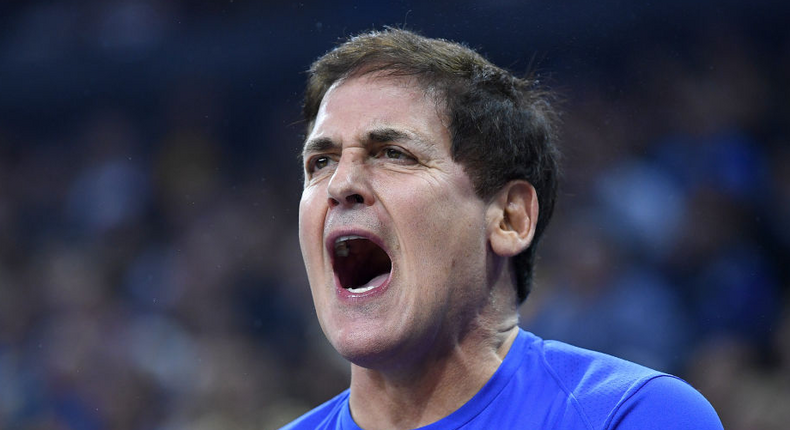 Team owner Mark Cuban of the Dallas Mavericks from behind the team bench reacts to the officiating against the Golden State Warriors during an NBA basketball game