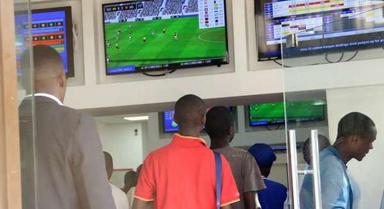 Kenyans place their bets at one of the many betting spots in Nairobi on July 30, 2016, along Market Street. 