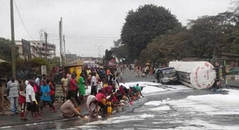 Residents scooping fuel as tanker overturns