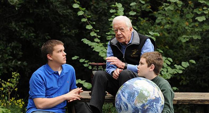 Jimmy Carter walks with his grandsons Jeremy Carter (R), 22, and Hugo Wentzel, 10 during a picnic event on October 31, 2009 in Istanbul, Turkey