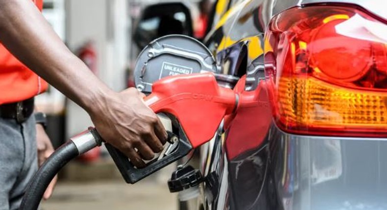 Attendant putting fuel in a car