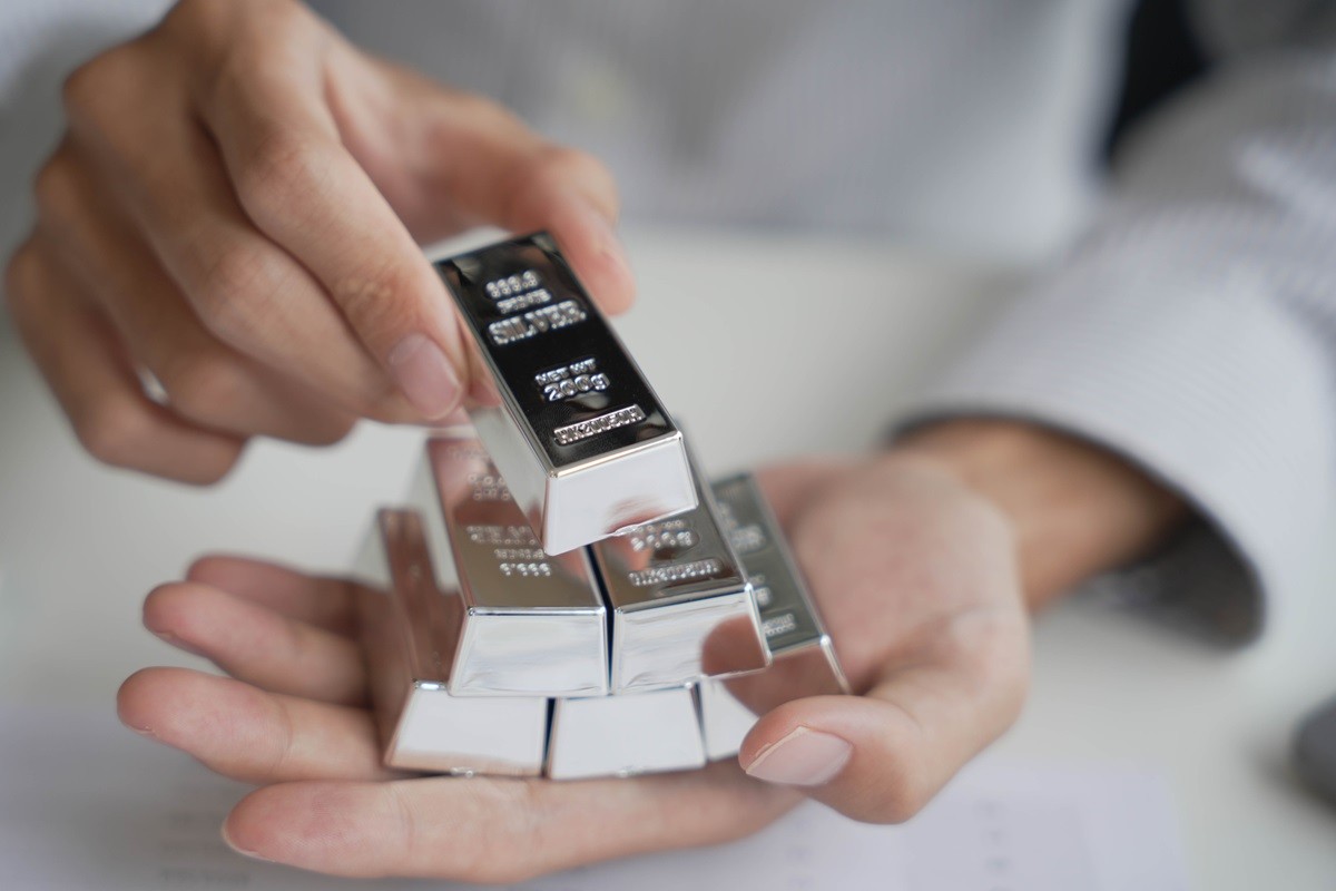 sztabki złota trzymane w dłoniach