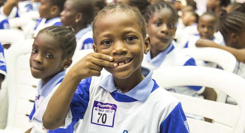 A pupil settles for the brush day and night pose at the Pepsodent 2019 World Oral Health Day celebration.