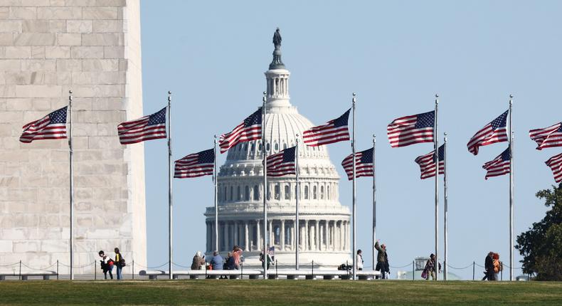 The Capitol building is seen through the American flags in Washington DC on October 20, 2022.Jakub Porzycki/NurPhoto/Getty Images